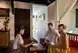 A spa attendents introducing different spa therapies to a couple in a family beach resort.
